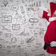Santa looking at a whiteboard with math equations on it